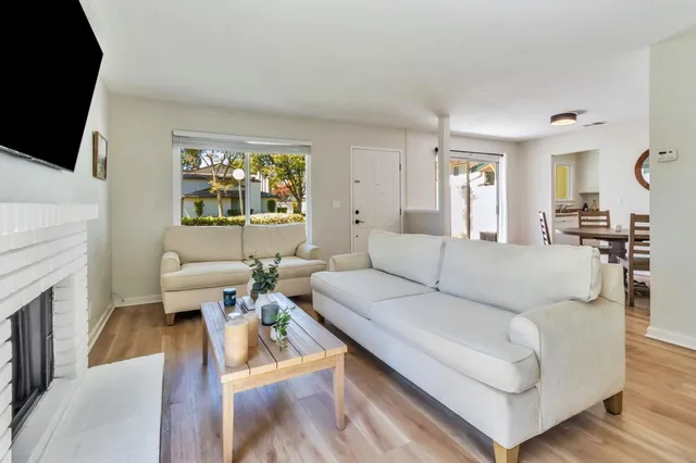 a living room with fireplace furniture and a flat screen tv