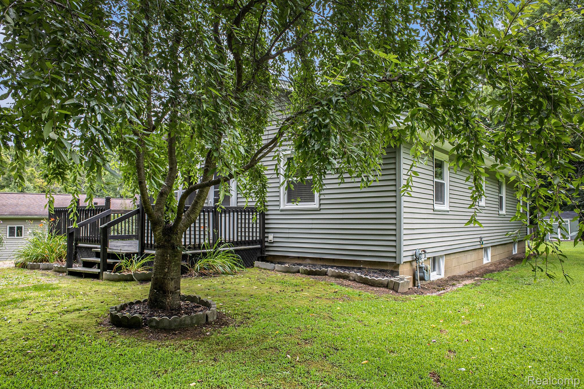 16568 28 Mile Road Albion, MI 49224 - Photo 21 of 26 View of home's exterior with a deck and a yard