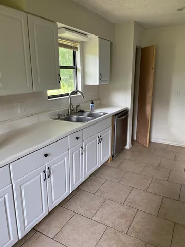 a kitchen with sink cabinets and window