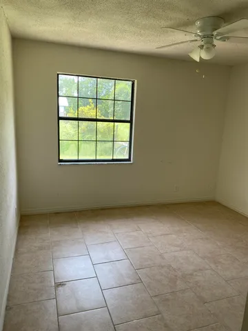 an empty room with a empty space and windows