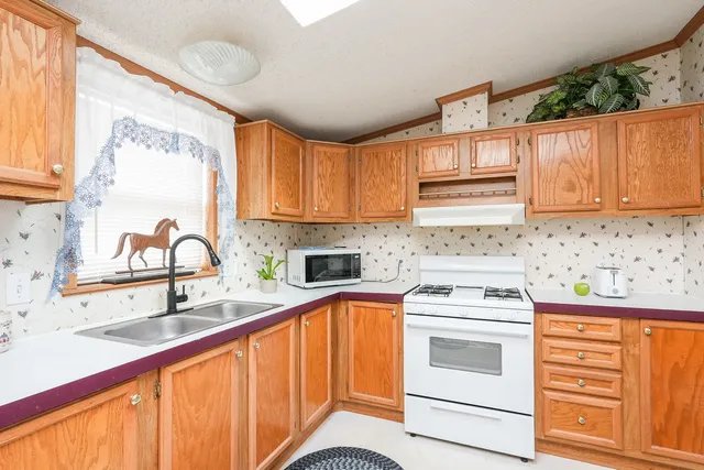 a kitchen with a sink stove and cabinets