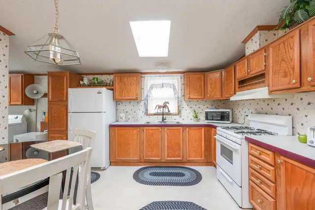 a kitchen with stainless steel appliances a stove a sink and a refrigerator