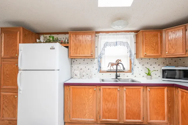 a kitchen with stainless steel appliances a refrigerator and a sink