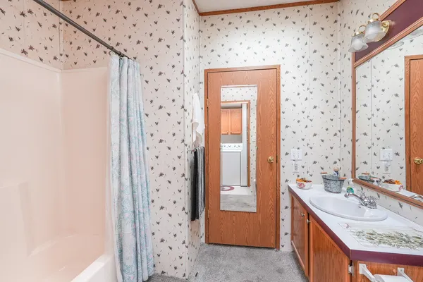 a bathroom with a sink a vanity and a shower