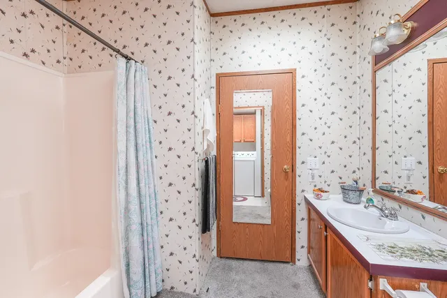 a bathroom with a sink a vanity and a shower