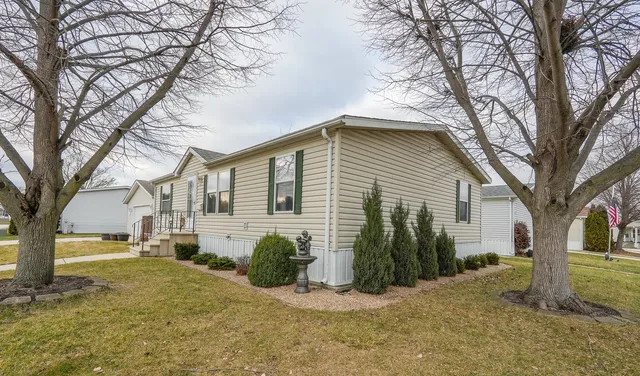 a view of a house with a yard covered in snow