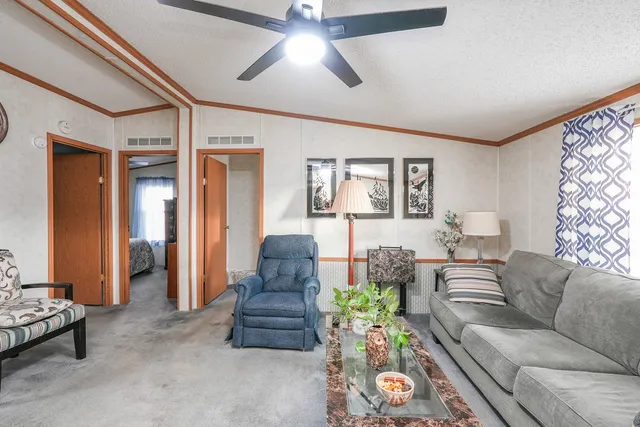 a living room with furniture and a chandelier