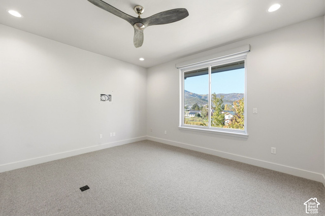 1067 Station Loop Road Park City, UT 84098 - Photo 16 of 38 Spacious room featuring neutral carpeting, a modern ceiling fan, recessed lighting, and a large window with roller shades