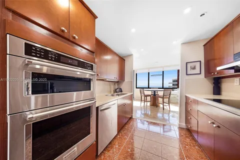 a kitchen with stainless steel appliances and white cabinets