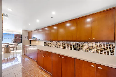 a view of a open kitchen with a sink and cabinets