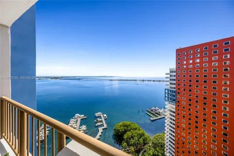 a view of a balcony next to a yard