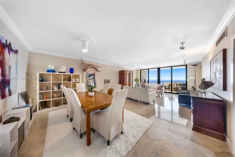 a living room with furniture a rug and a bookshelf