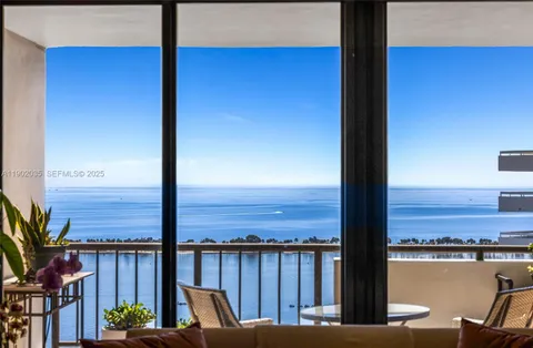 a view of a balcony with chair and wooden floor