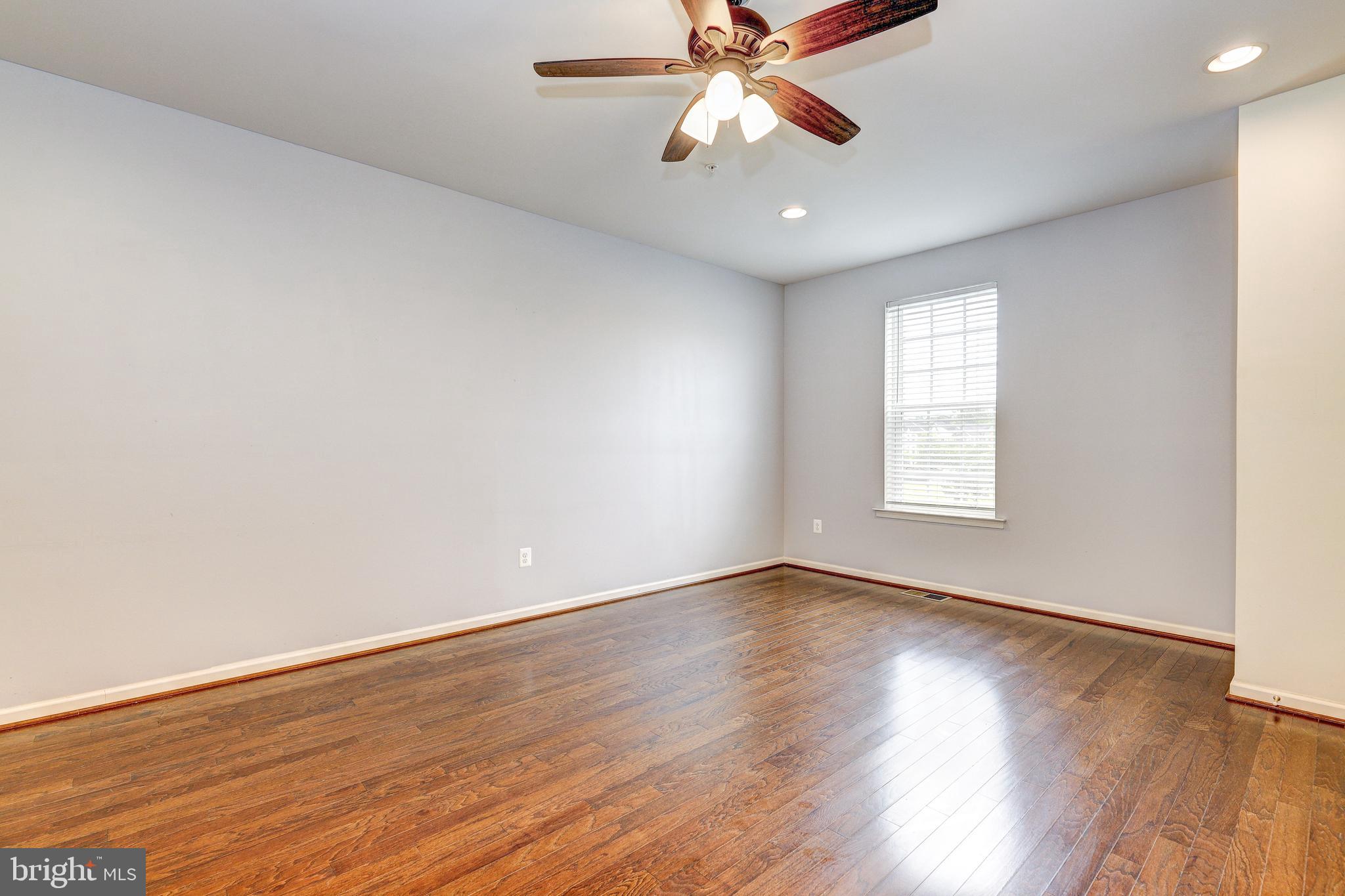 912 Winter Run Road Middle River, MD 21220 - Photo 22 of 55 an empty room with wooden floor chandelier fan and windows