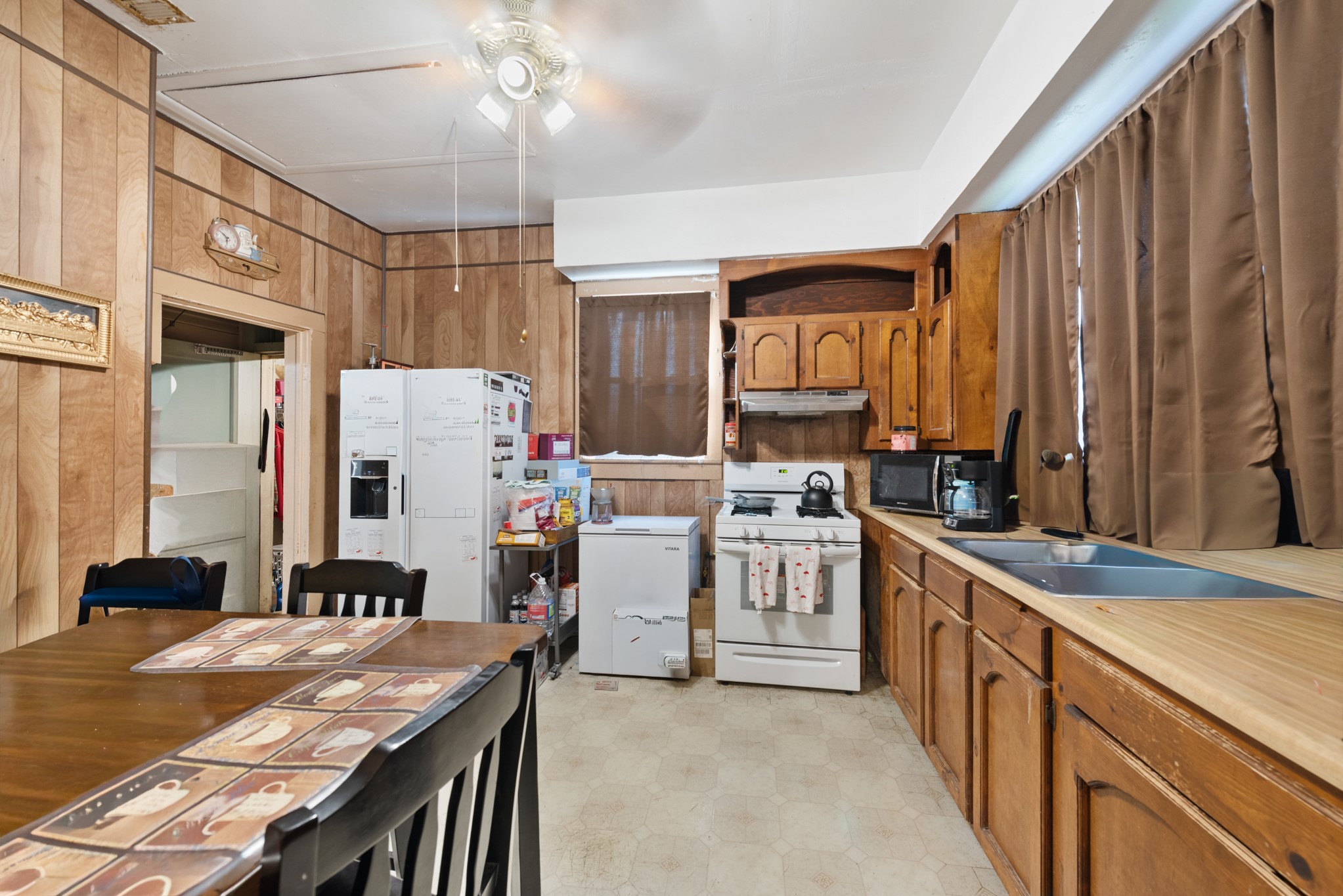 917 Trinity Street Lockhart, TX 78644 - Photo 9 of 13 a kitchen with white cabinets and stainless steel appliances