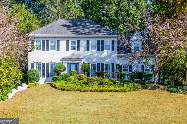 a view of a house with pool and a yard