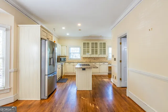 a kitchen with granite countertop a sink stainless steel appliances and cabinets