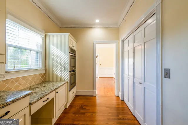 a view of a room with wooden floor and windows