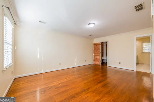 a view of a livingroom with a hardwood floor and a ceiling fan