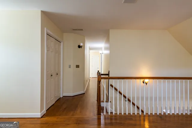 a view of balcony with wooden floor and fence