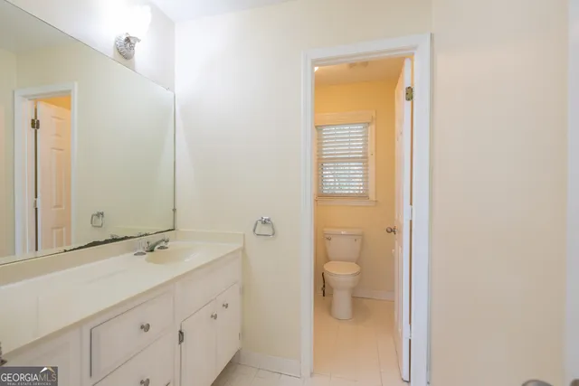 a backyard of a house with barbeque oven and wooden fence
