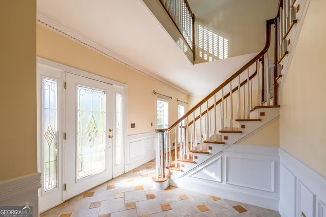a view of an empty room with a fireplace and wooden floor
