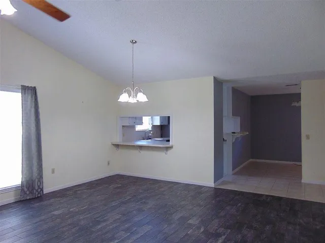 a view of a room with wooden floor