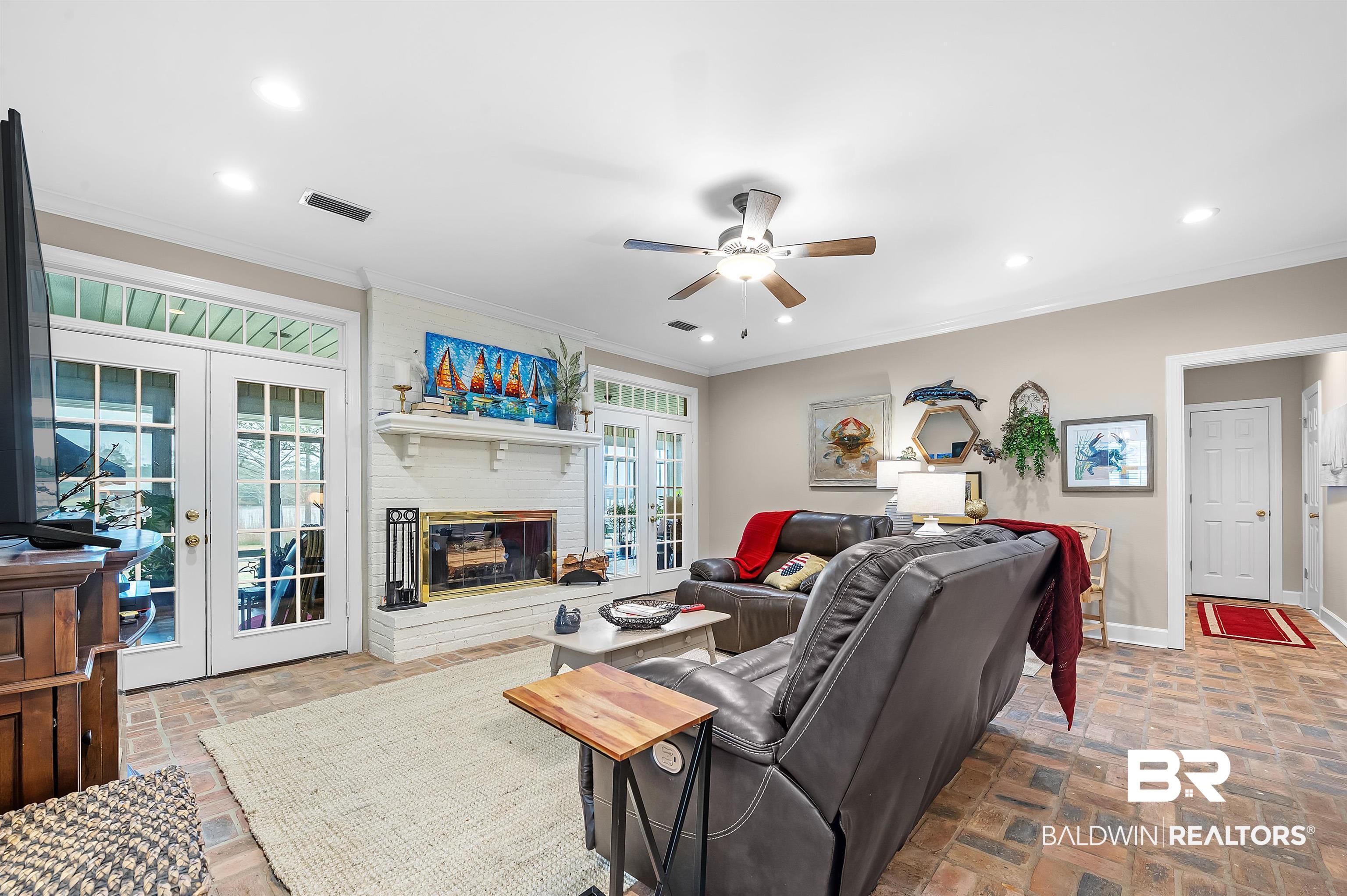 8915 Bay Point Drive Elberta, AL 36530 - Photo 14 of 74 Living room with brick floor, french doors, visible vents, and a healthy amount of sunlight