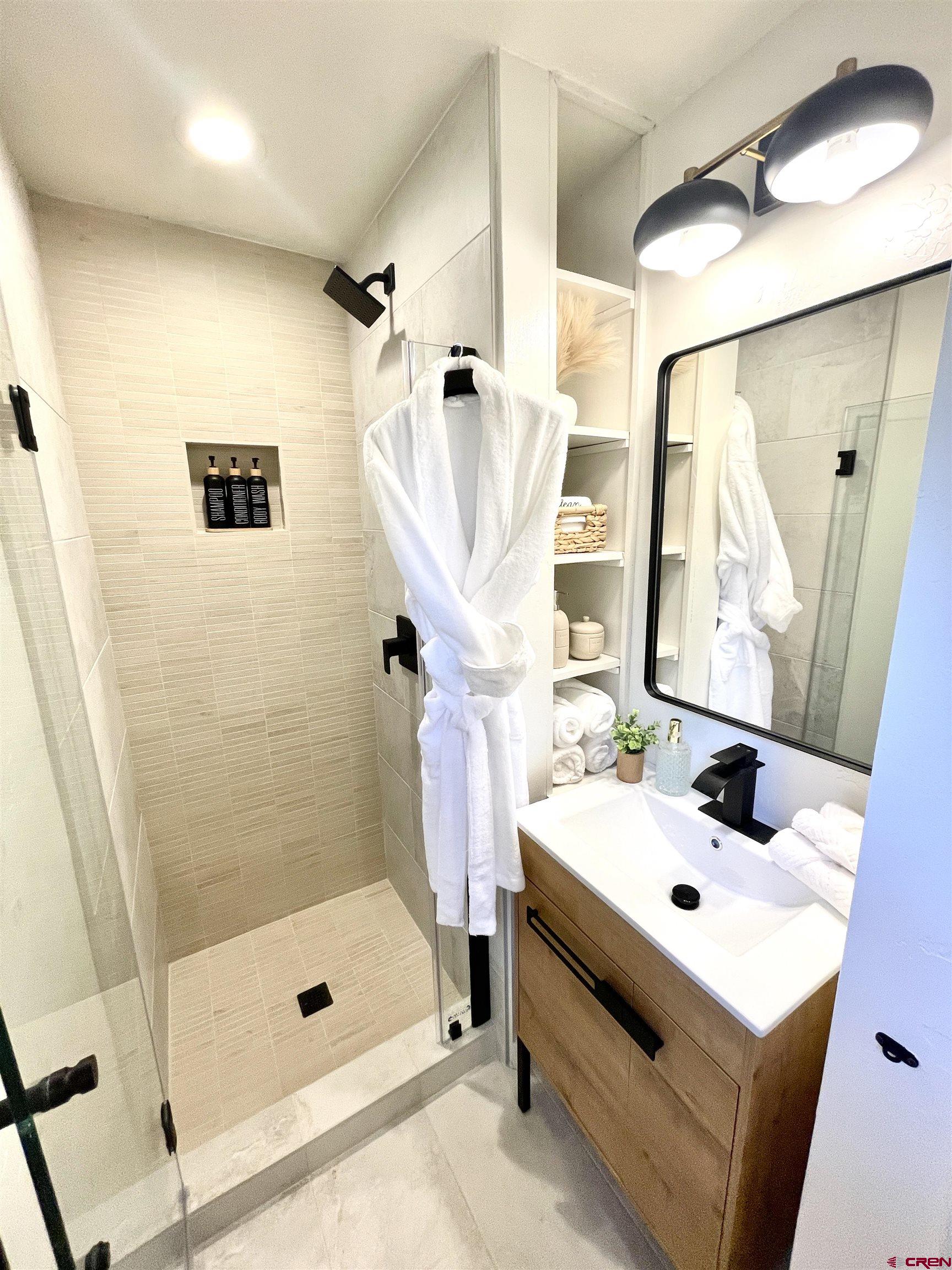 170 Lower Allen Road Crested Butte, CO 81224 - Photo 17 of 42 a bathroom with a sink a mirror a vanity and shower