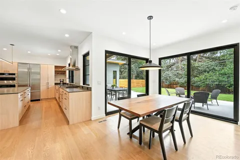 a dining room with furniture a chandelier and wooden floor