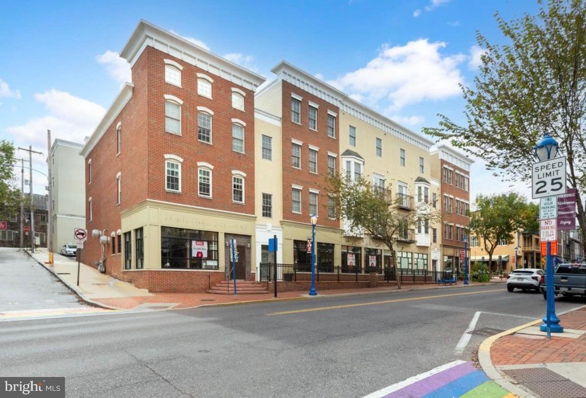 a city street lined with buildings and trees