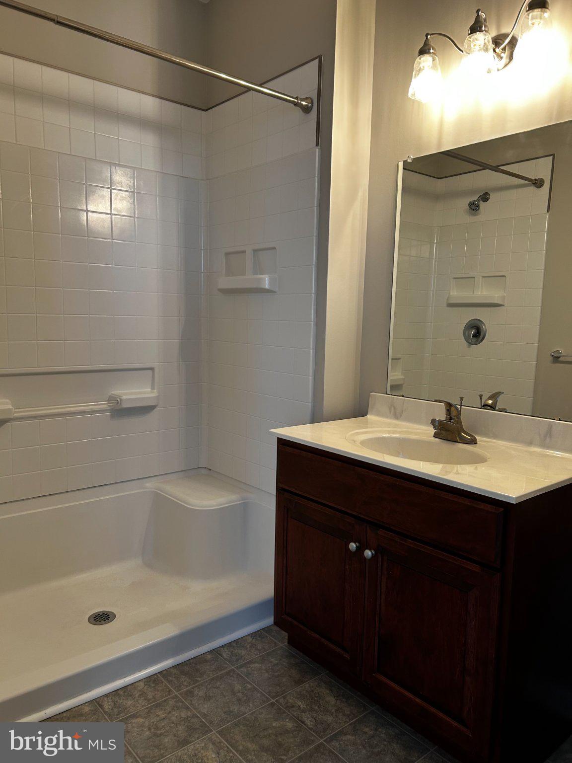 134 Bridge Street, Unit 201 Phoenixville, PA 19460 - Photo 4 of 12 a bathroom with a bath tub sink vanity and mirror