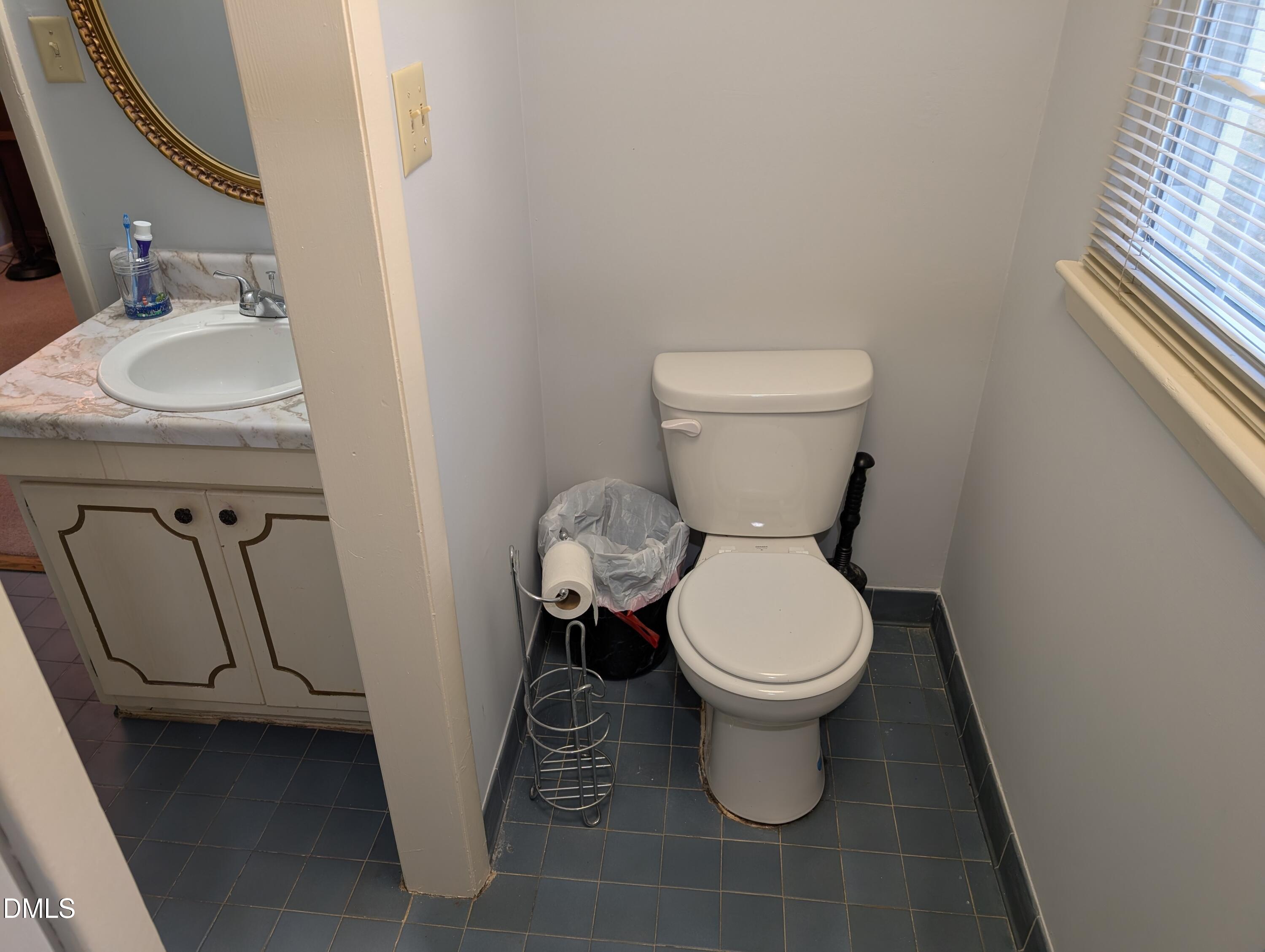 5602 Falls Of Neuse Road, Unit A Raleigh, NC 27609 - Photo 11 of 31 a white toilet sitting next to a bathroom sink