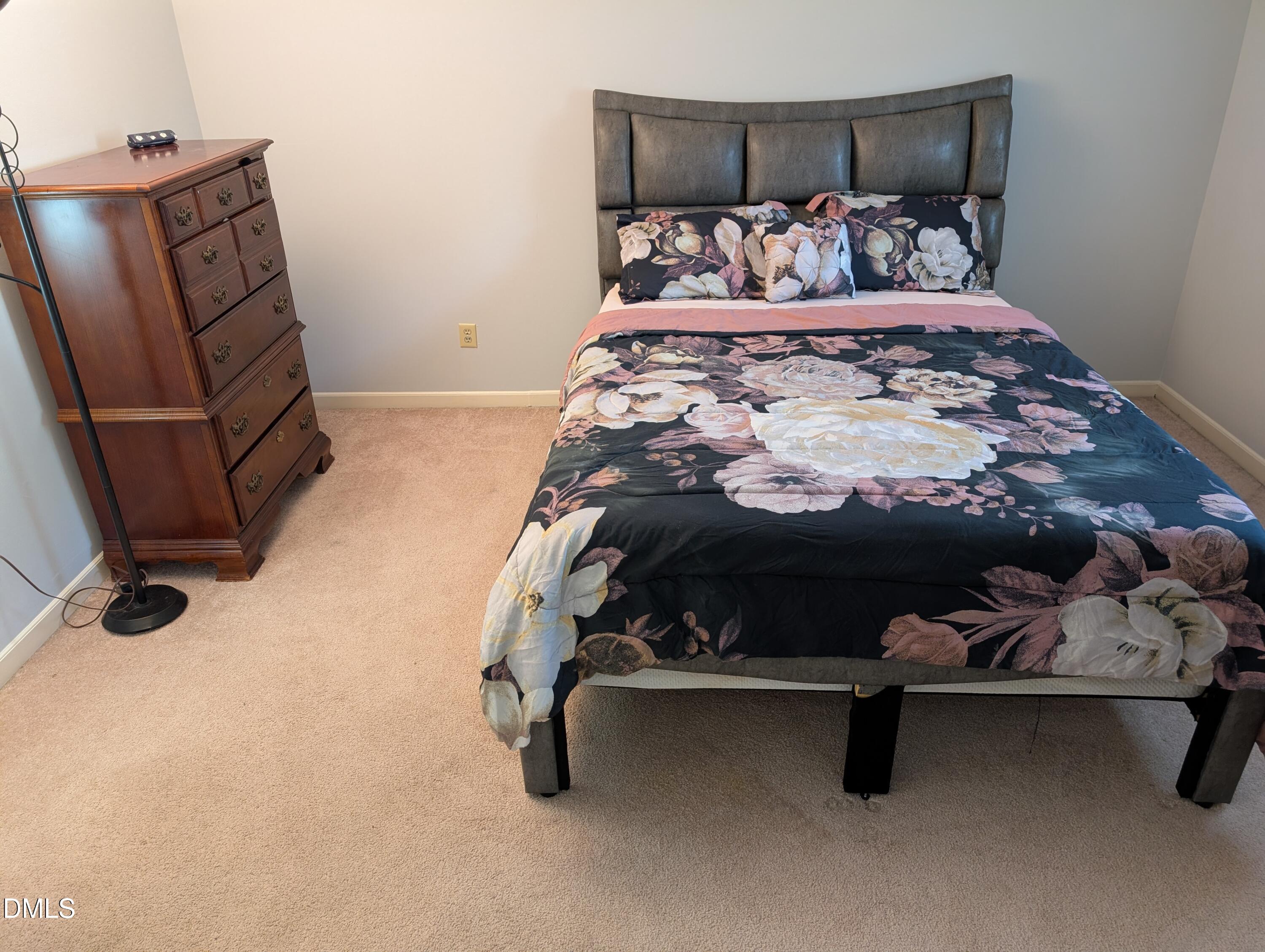 5602 Falls Of Neuse Road, Unit A Raleigh, NC 27609 - Photo 13 of 31 a bed sitting in a bedroom next to a window