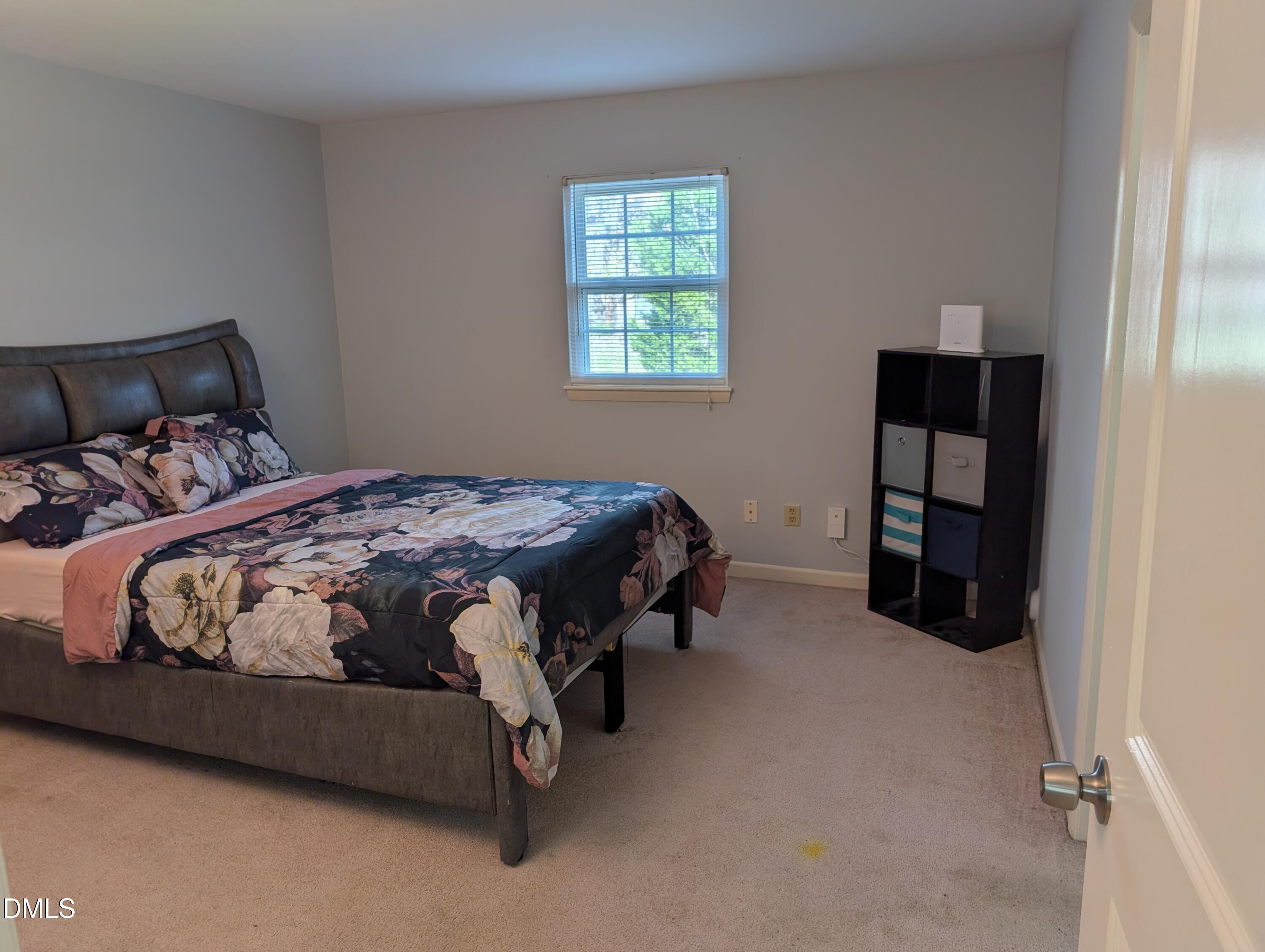 5602 Falls Of Neuse Road, Unit A Raleigh, NC 27609 - Photo 14 of 31 a bedroom with a bed and a window