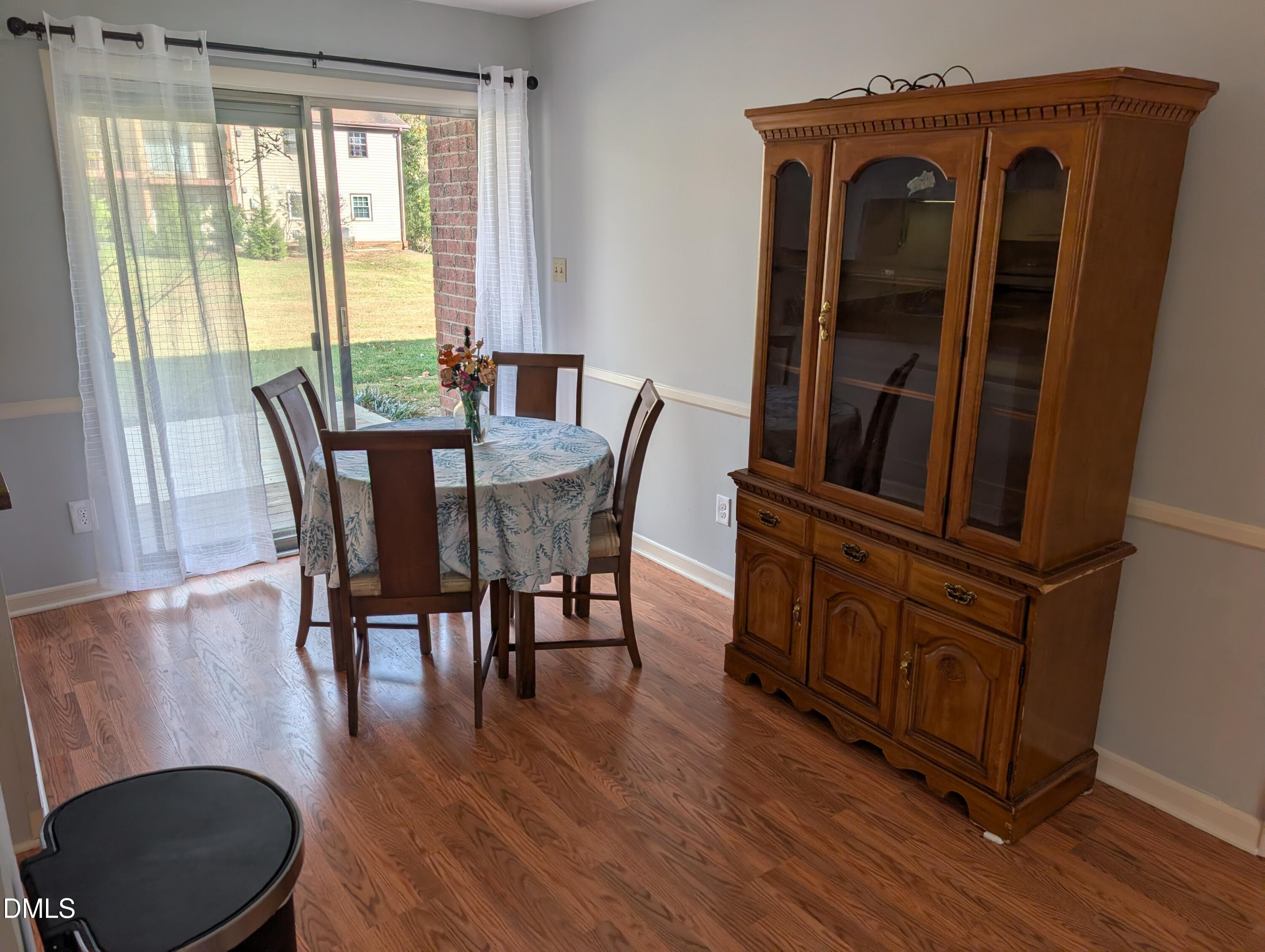 5602 Falls Of Neuse Road, Unit A Raleigh, NC 27609 - Photo 20 of 31 a view of a dining room with furniture window and wooden floor