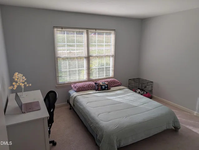 a bedroom with a bed and a television