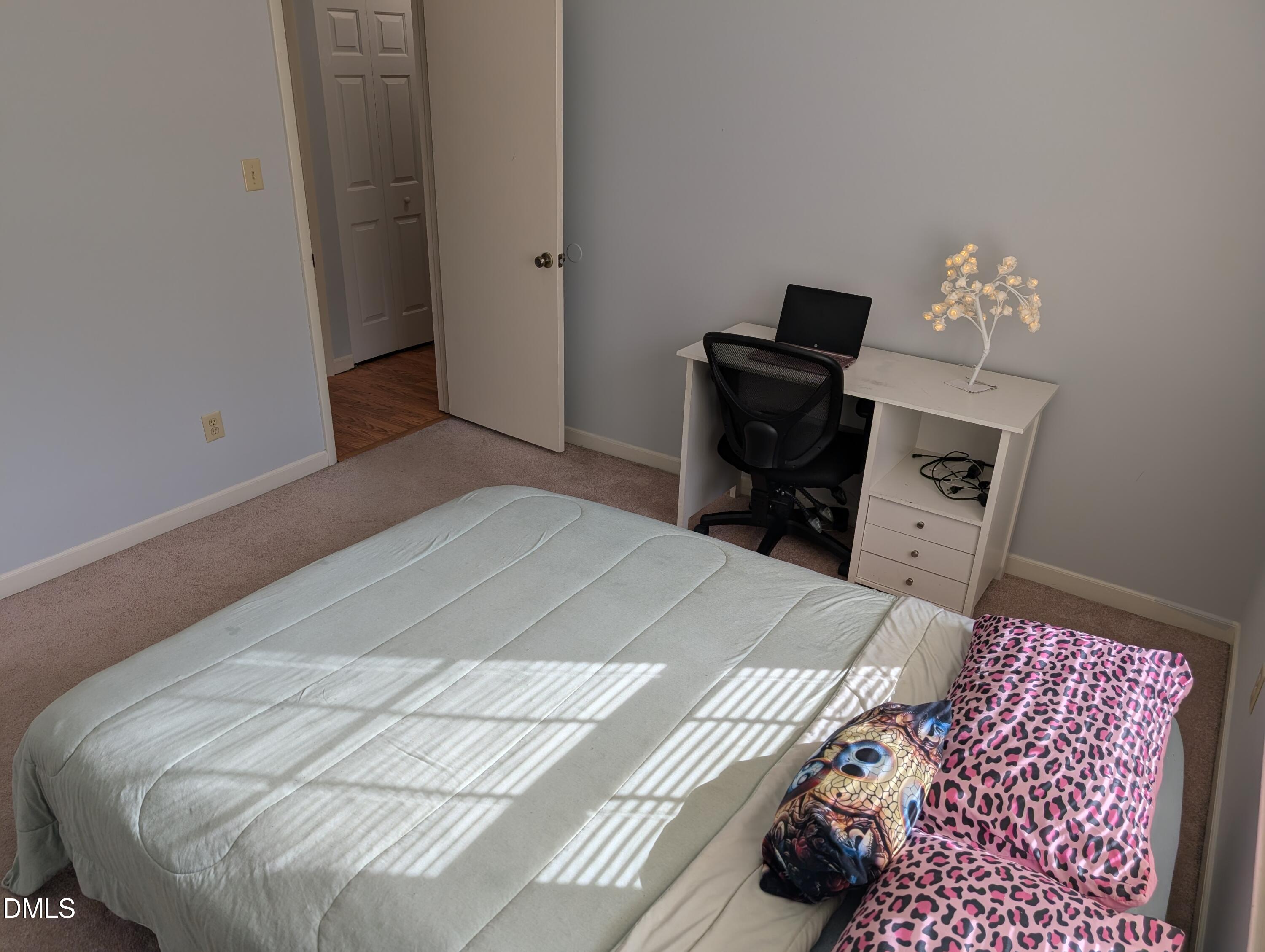 5602 Falls Of Neuse Road, Unit A Raleigh, NC 27609 - Photo 5 of 31 a bedroom with a bed and a television