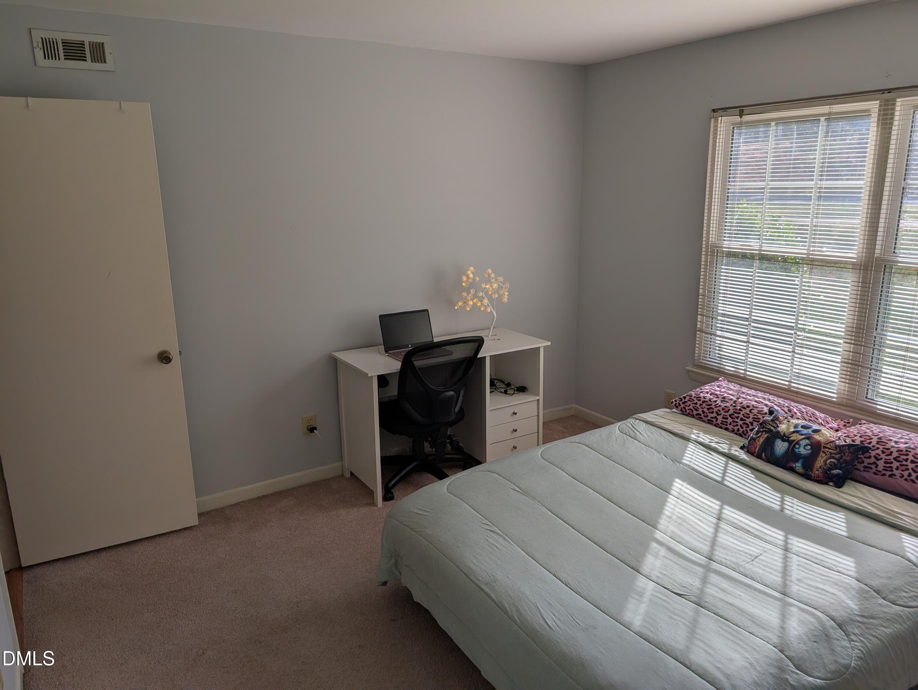 5602 Falls Of Neuse Road, Unit A Raleigh, NC 27609 - Photo 6 of 31 a bedroom with a bed and a window