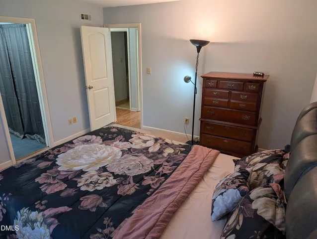 a bedroom with a bed and a mirror