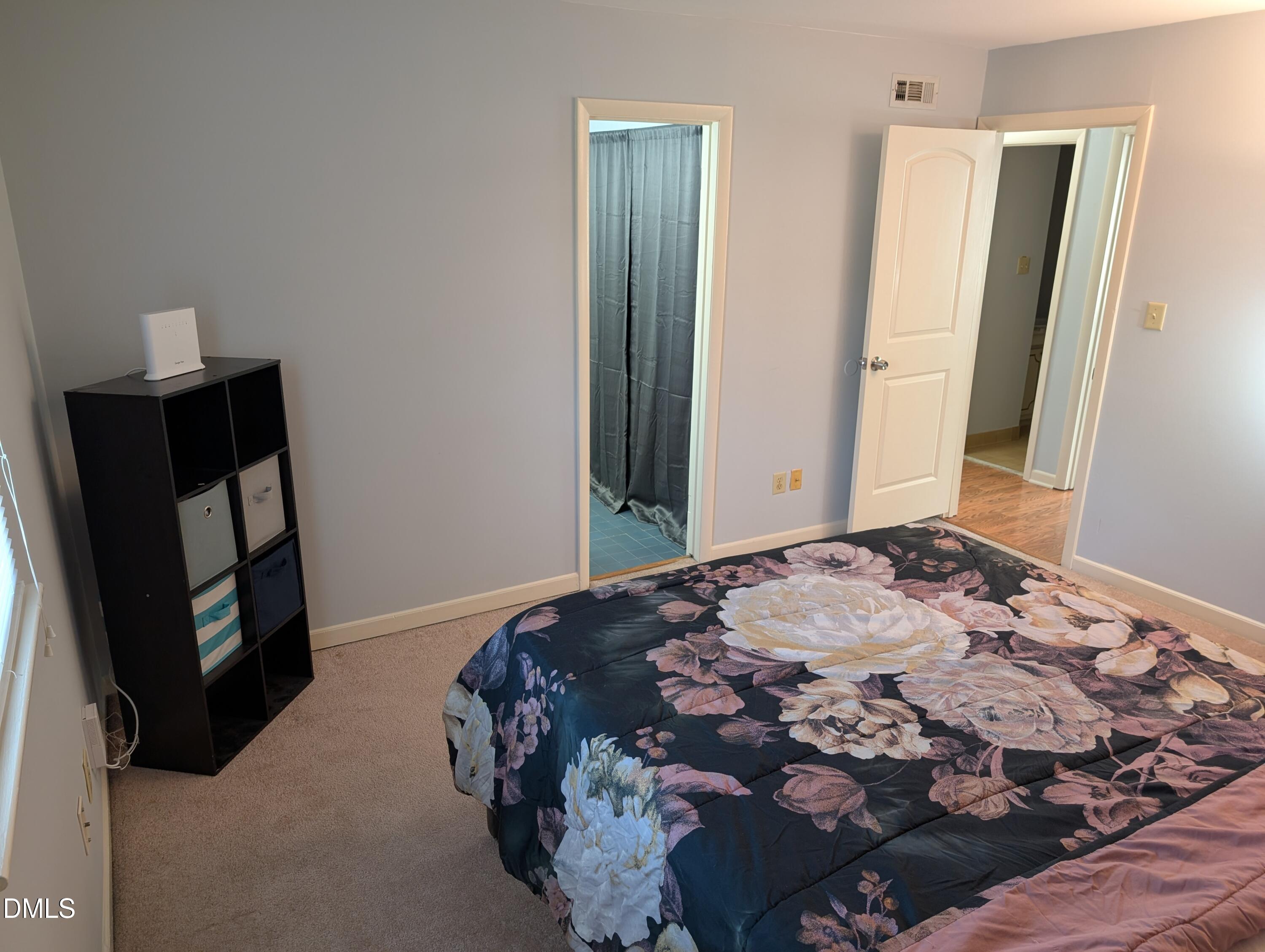 5602 Falls Of Neuse Road, Unit A Raleigh, NC 27609 - Photo 9 of 31 a bedroom with a bed and a mirror