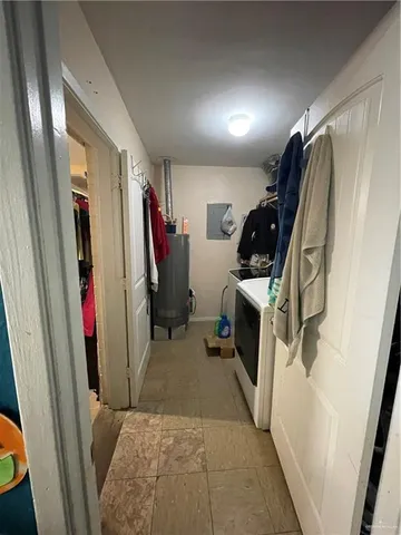 a view of walk in closet with clothes