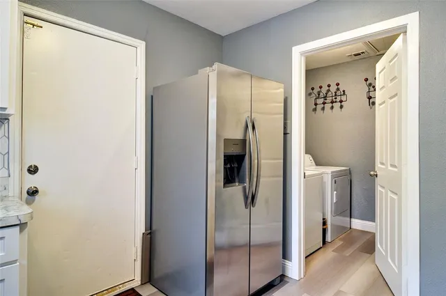a bathroom with a glass shower door and a sink