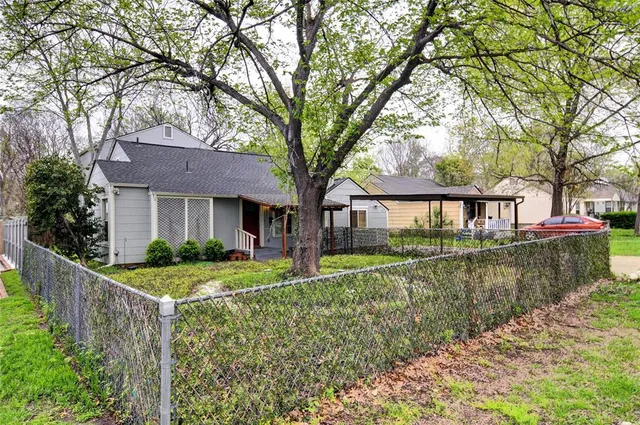 a front view of a house with a yard table and chairs