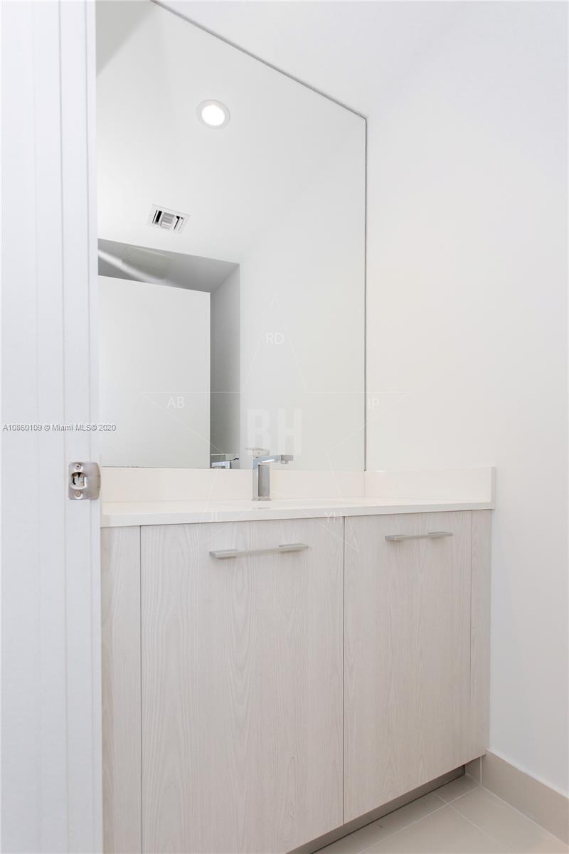 55 Southwest 9th Street, Unit 2210 Miami, FL 33130 - Photo 20 of 24 a bathroom with a sink and a mirror