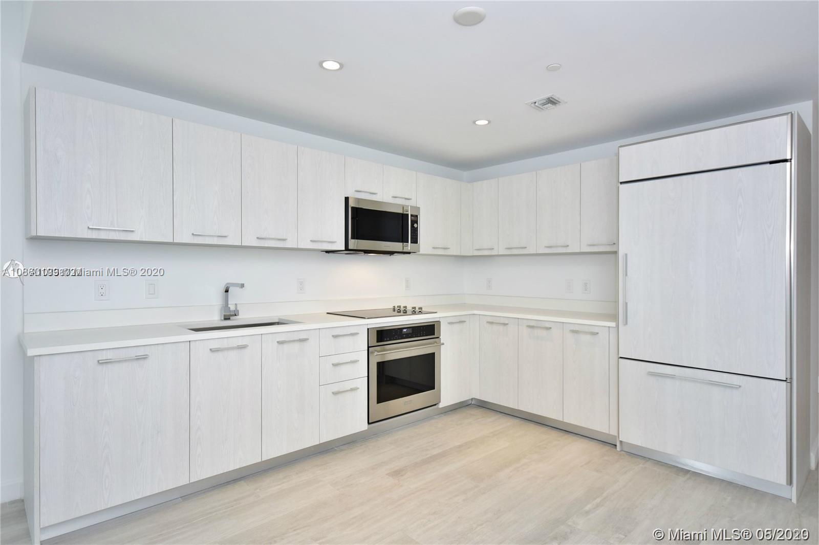 55 Southwest 9th Street, Unit 2210 Miami, FL 33130 - Photo 22 of 24 a kitchen with cabinets stainless steel appliances and a counter space