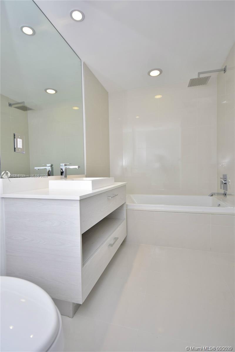 55 Southwest 9th Street, Unit 2210 Miami, FL 33130 - Photo 24 of 24 a bathroom with a double vanity sink mirror and toilet