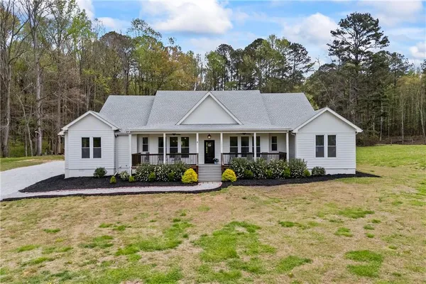 a front view of a house with a yard and porch