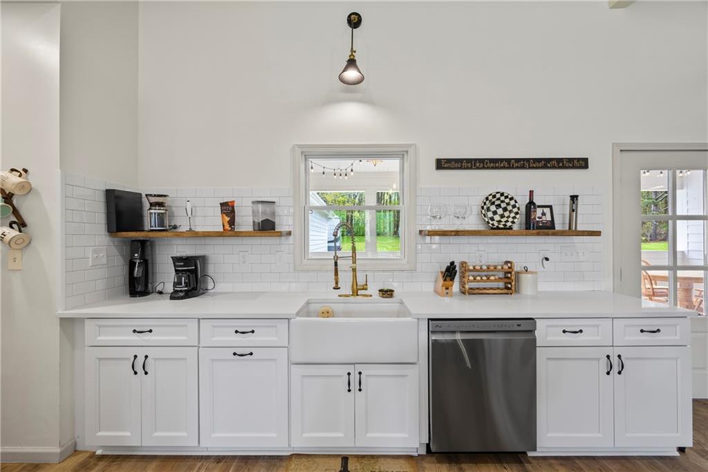 1308 Highway 82 Winder, GA 30680 - Photo 15 of 54 a kitchen with cabinets appliances a sink and a window
