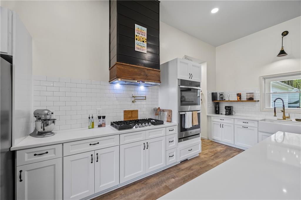 1308 Highway 82 Winder, GA 30680 - Photo 17 of 54 a kitchen with cabinets stainless steel appliances and a sink